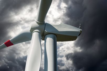 Wind turbine generator against a dark sky