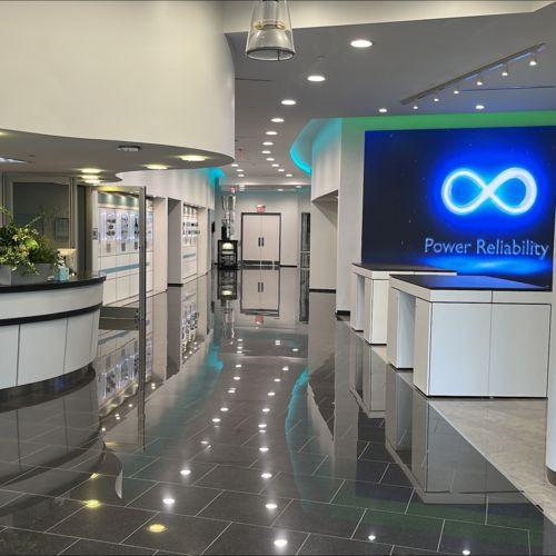A photo of Phoenix Contact's Houston CTC lobby interior, featuring a modern design and displays with monitors and products.