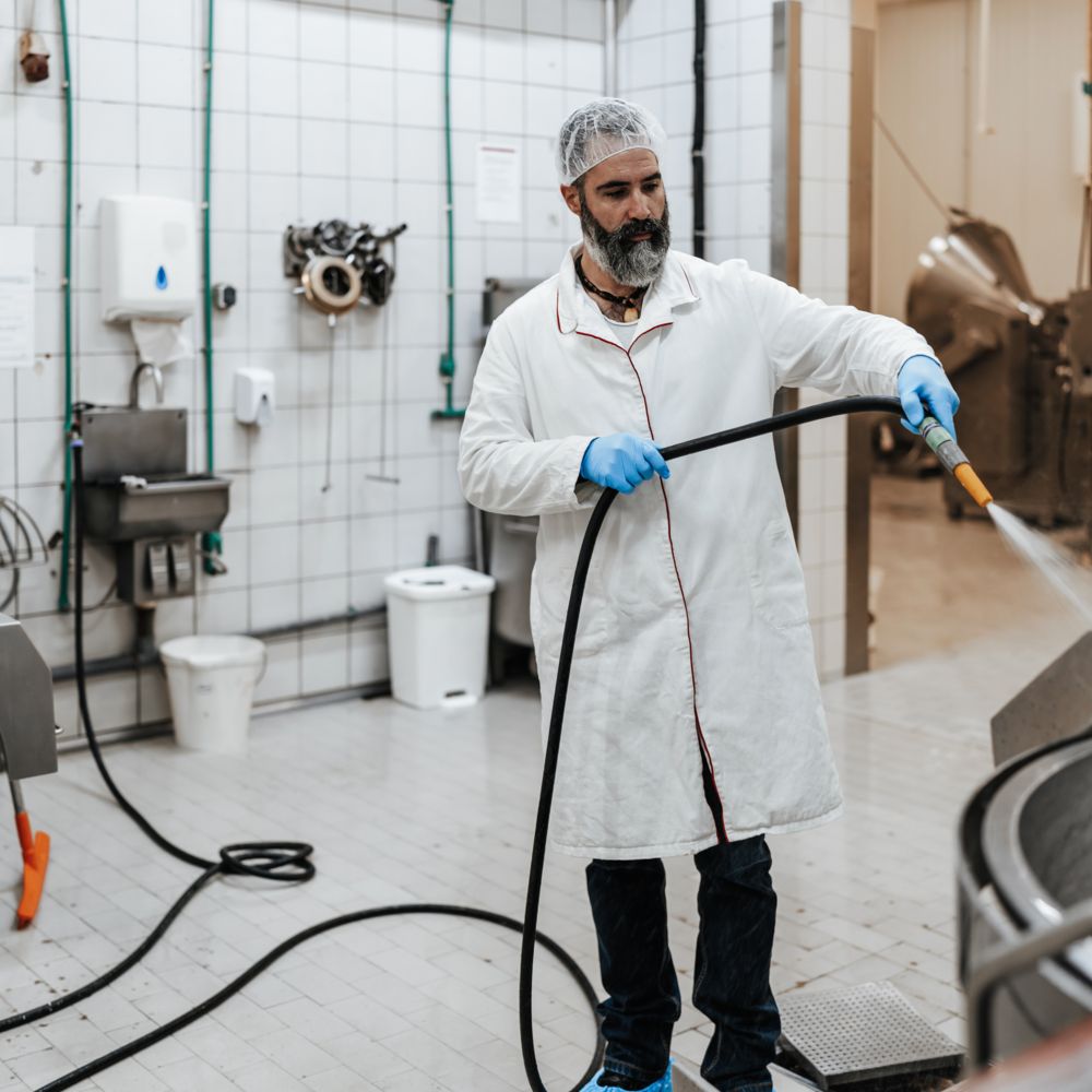 Employee during cleaning in a slaughterhouse