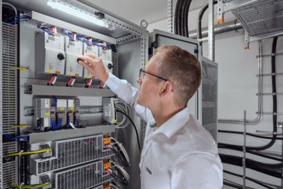Employee at a control cabinet