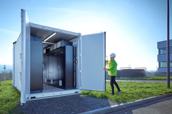 A Phoenix&nbsp;Contact employee opening the battery storage system in front of the All&nbsp;Electric&nbsp;Society&nbsp;Factory in Blomberg, Germany