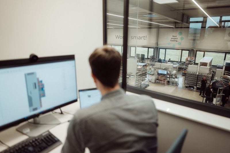 Office of a design engineer with a view of the TOBOL production hall