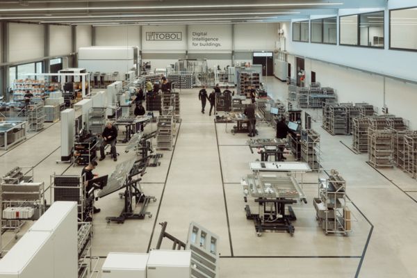 View of the new production hall at Tobol with individual workstation solutions in control cabinet building