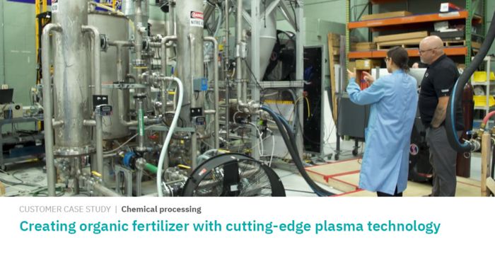Two men stand in a chemical processing plant