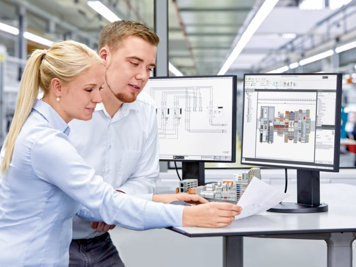 Two people working with the PROJECT complete software