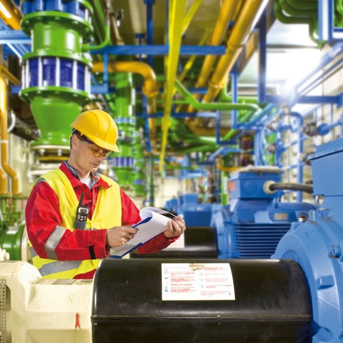 Collaborateurs devant des moteurs de l'industrie des process