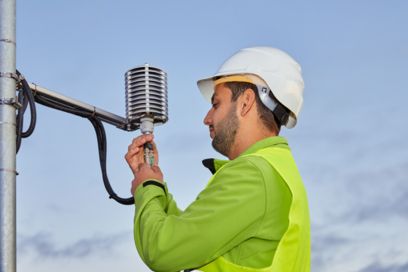 Technician checking sensors for weather data acquisition