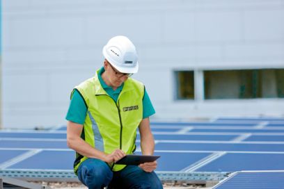 Technician in a solar park configuring inverter communication