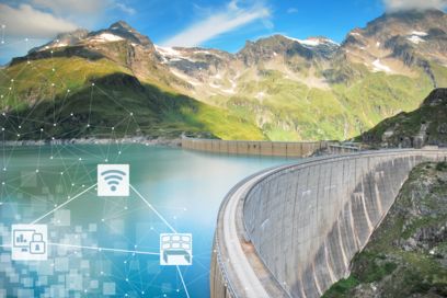 Hydroelectric power plant with reservoir and mountains in background