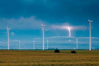 Wind turbines in a field with lightning