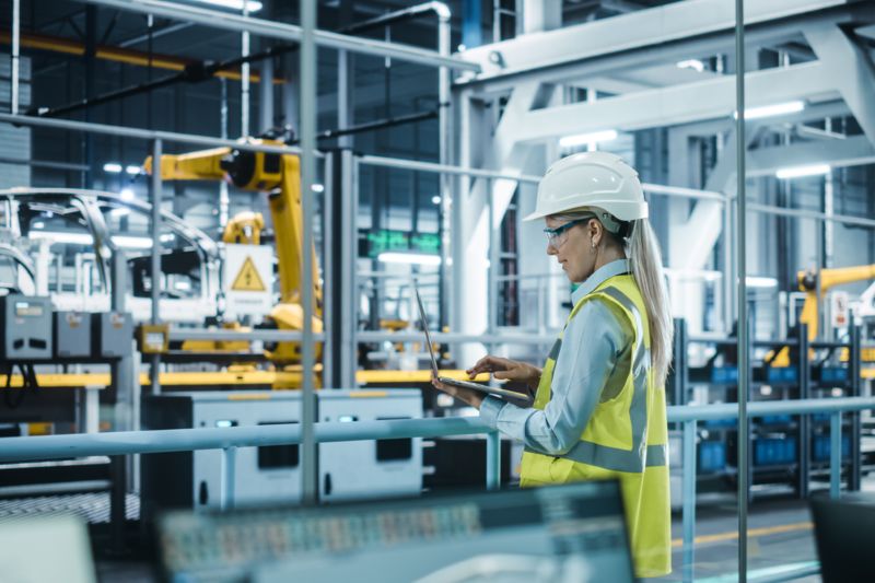 Person with a tablet in a production plant