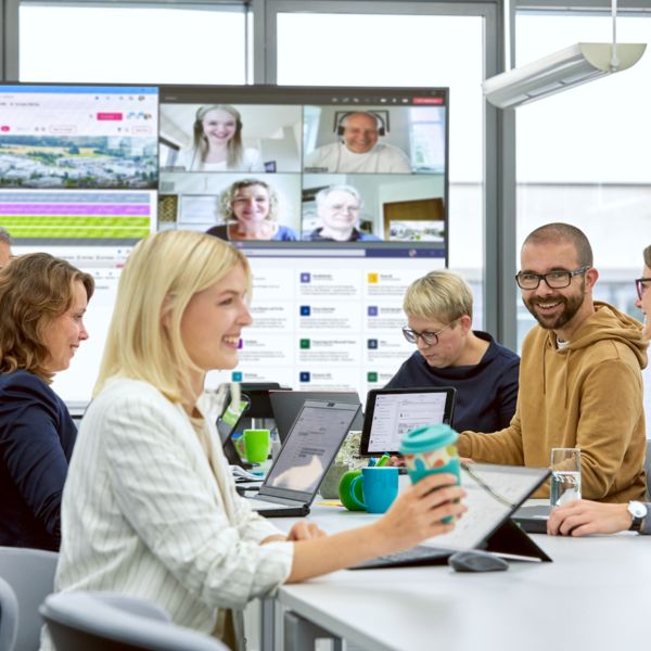 Mitarbeitende arbeiten hybrid zusammen