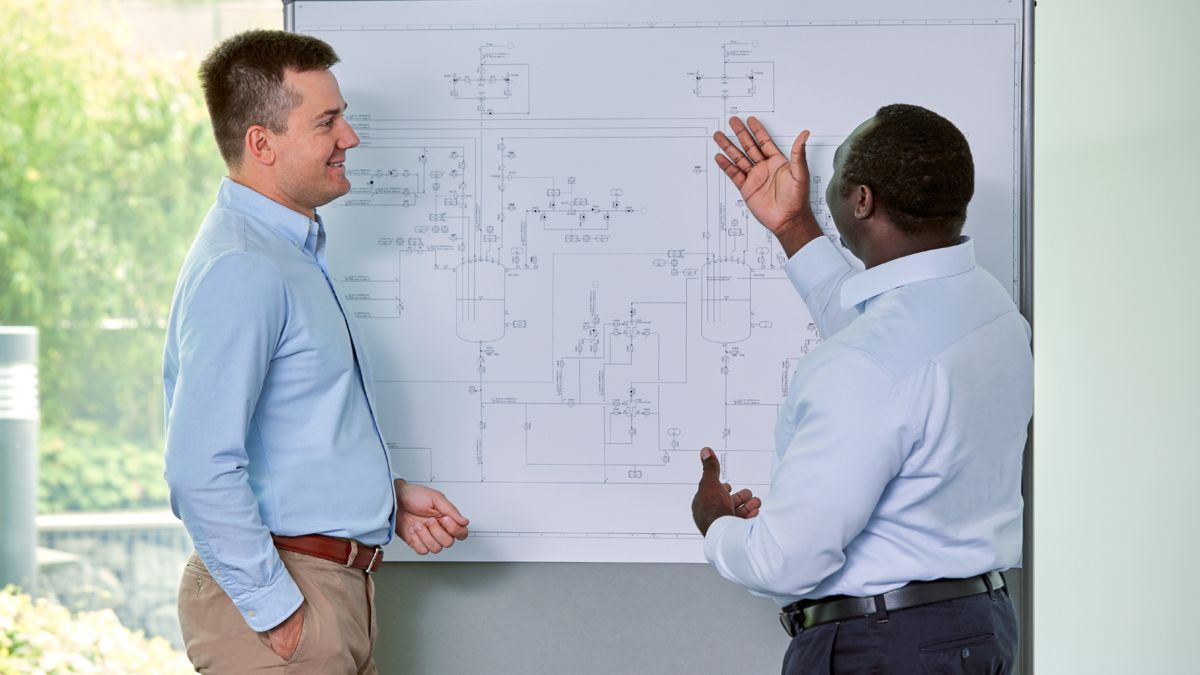 Two men working on a planning sketch