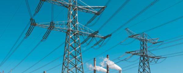 Transmission towers with power station in the background