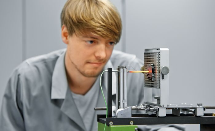 Phoenix Contact employee examining a glowing wire