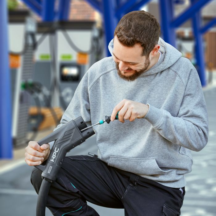 Service technician replaces the mating face of an HPC charging connector at a fast charging station