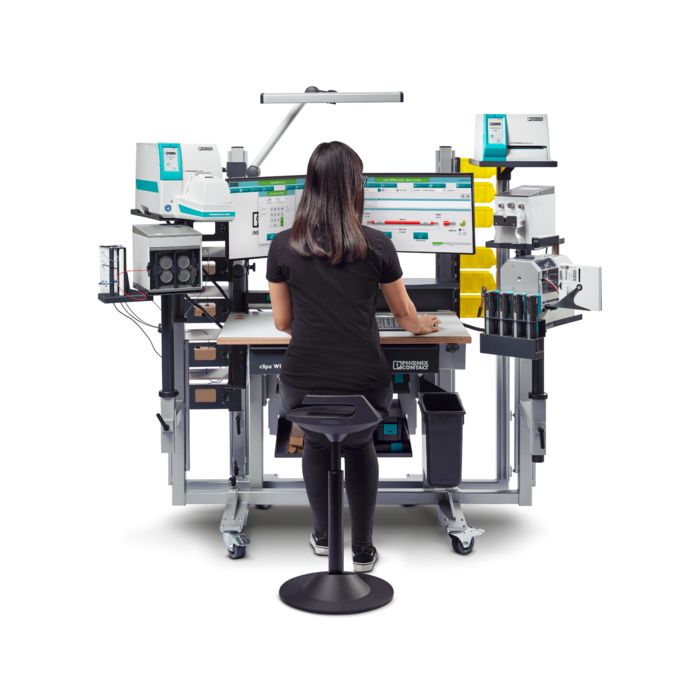 Woman sat working at the clipx WIRE assist worker assistance system