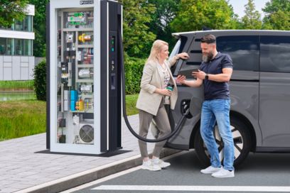 Woman charging an electric car with a charging cable