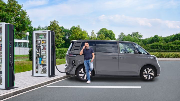 Una persona carga el vehículo eléctrico en una estación de recarga DC