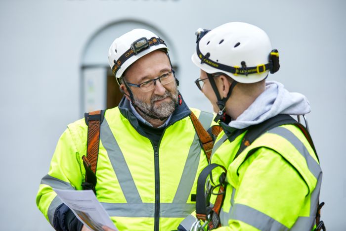 Employees discuss services for the safety of machinery and systems