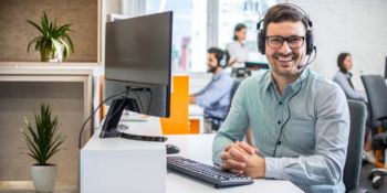 Employee with headset sitting at his desk