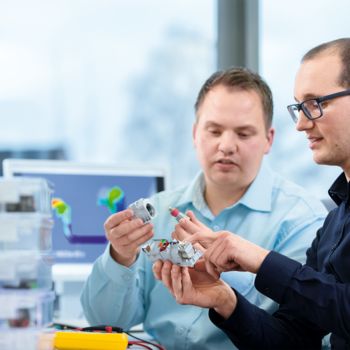 Two men with surge protection products from Phoenix Contact
