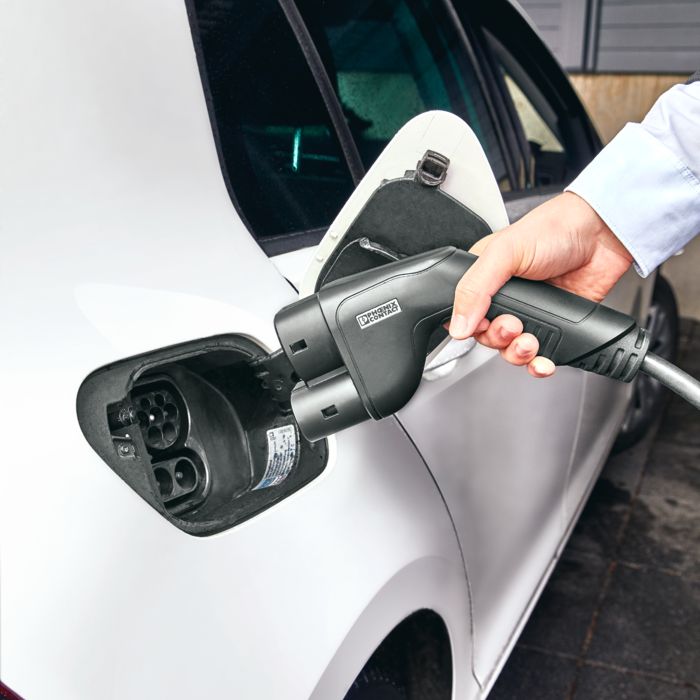 A CCS charging connector is plugged into an electric car