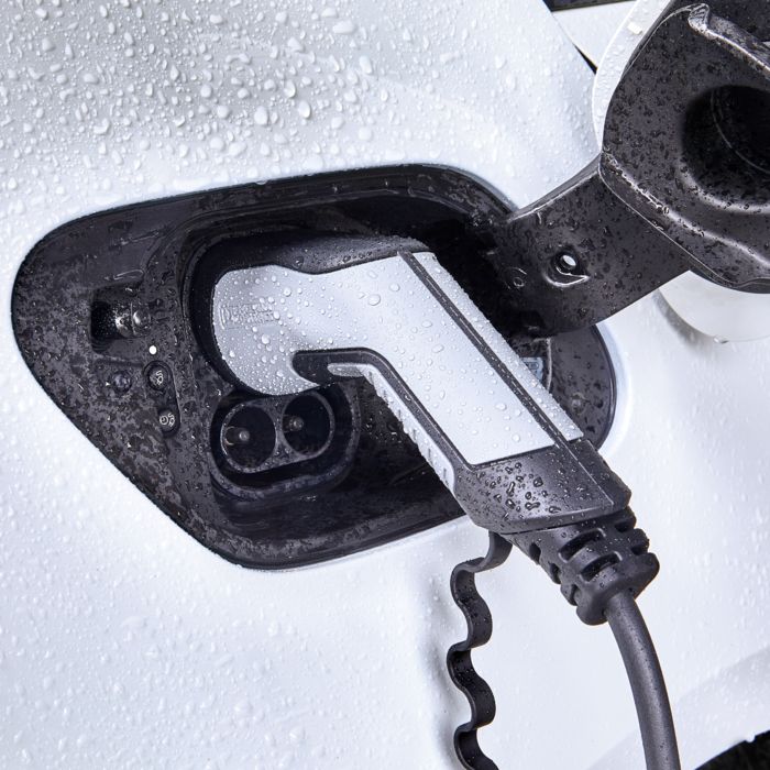 CHARX connect comfort AC charging connector being used outdoors in the rain