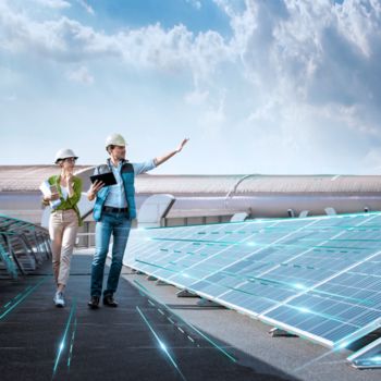 Employees next to a solar system
