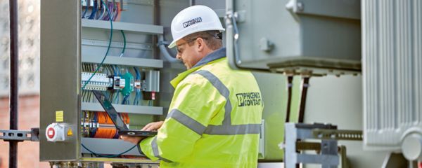 Worker in front of a control cabinet
