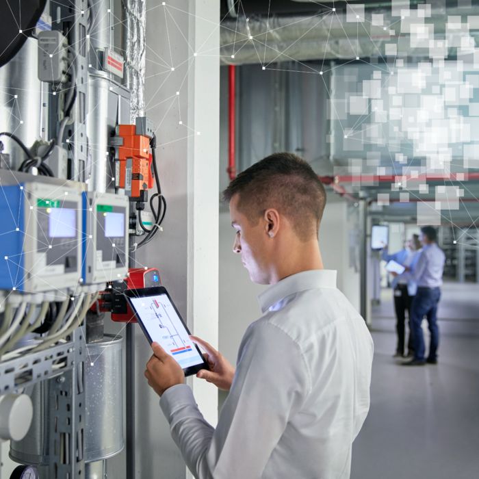 Person evaluating data from the Smart Building Cloud with a tablet