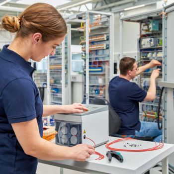 People during control cabinet wiring