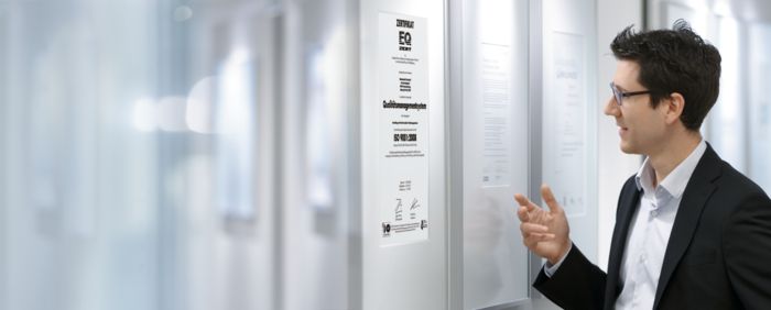 Phoenix Contact employee in front of issued certificates