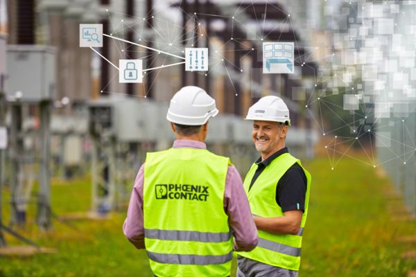 Two people with high-vis vests in an electrical plant