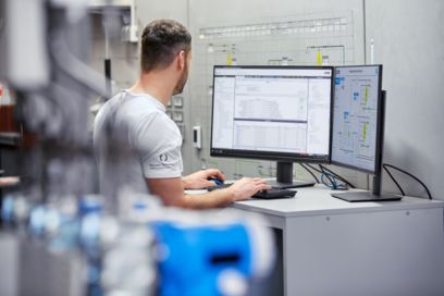 Man at a computer in the control room of a power station