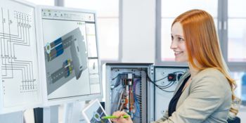 Woman using clipx ENGINEER engineering software on a PC