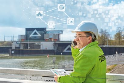 Phoenix Contact employee on the phone in front of a waterway