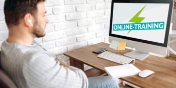 Man in front of screen during “online training”