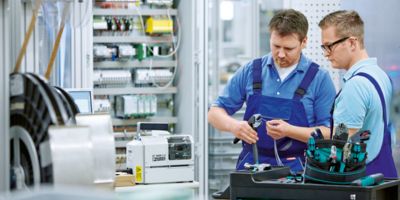 Technician in front of a control cabinet