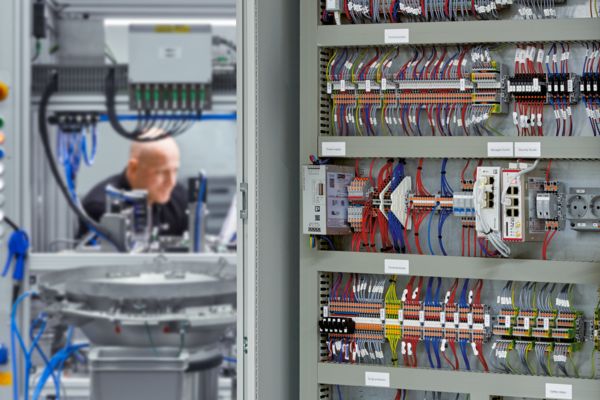Open control cabinet with machine