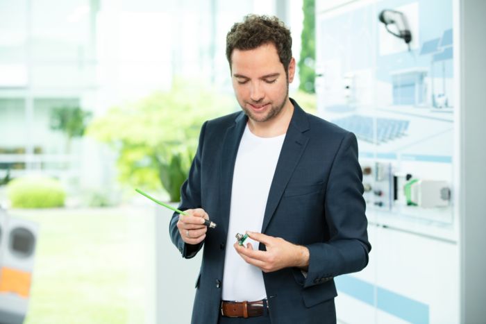 Tim Kindermann, Product Manager at Phoenix Contact, with an SPE M8 connector