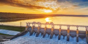 Hydroelectric power station with reservoir at sunset