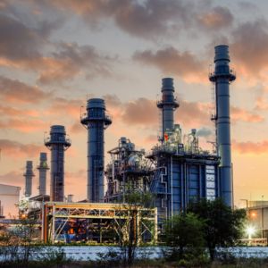 Illuminated natural gas-fired power station at dusk