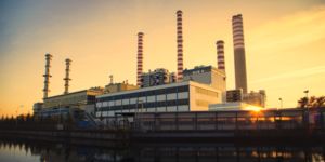 Oil-fired power station on the river at sunset