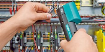 Wires being processed directly at the control cabinet with the Crimphandy portable automatic stripping and crimping device